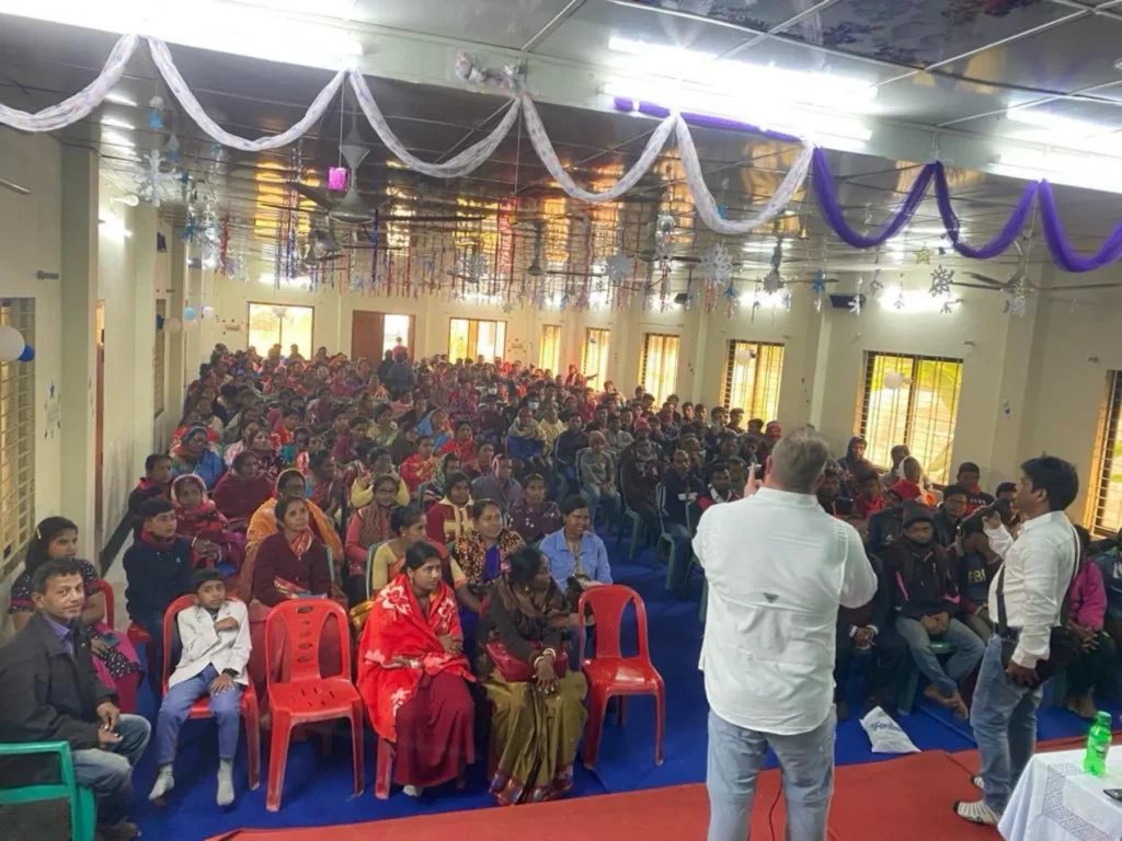 Missionary team sharing the Gospel in a village Gospel outreach event with local community Discipleship training program for new believers Volunteers praying for mission work abroad Children participating in Bible study on mission trip Outdoor Jesus Film screening for villagers Team providing meals and support during outreach Local church packed for Gospel presentation Missionaries teaching faith to new believers Supporters giving generously to Christian missions Prayer meeting for global mission trips Team walking through village during outreach Sharing the Gospel with Hindu villagers in a temple Community gathering for evangelism event Missionary teaching Scripture during small group Donors helping fund international mission programs Team preparing materials for Gospel outreach Local children learning about Jesus during mission Volunteers praying over new believers Mission trip team serving the community with love